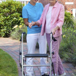 Care assistant helping an elderly lady.